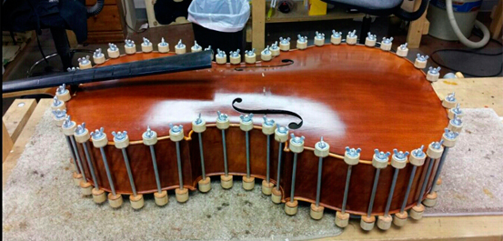 Once we completed internal repairs, we replaced the top of the cello.